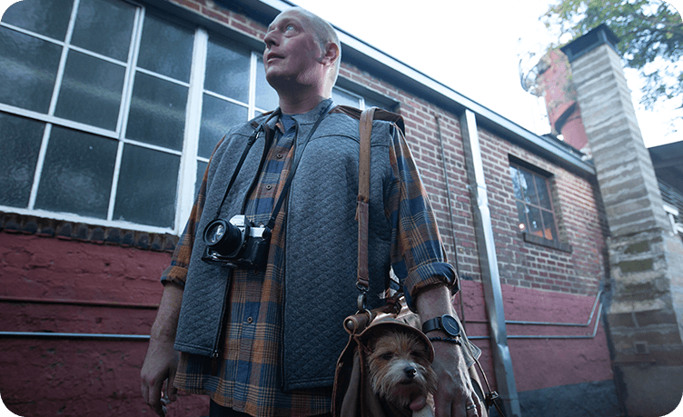 Troy standing with his dog and camera